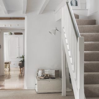 hallway with white wall and carpet on floor