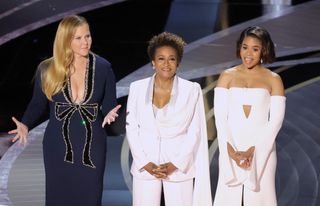 Co-hosts Amy Schumer, Wanda Sykes, and Regina Hall speak onstage during the 94th Annual Academy Awards at Dolby Theatre on March 27, 2022 in Hollywood, California.