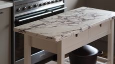 a marble topped beige kitchen island