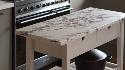 a marble topped beige kitchen island