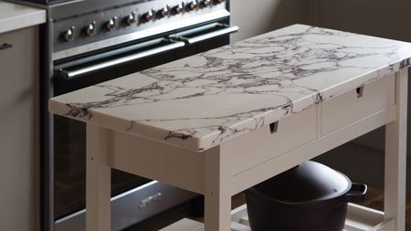 a marble topped beige kitchen island