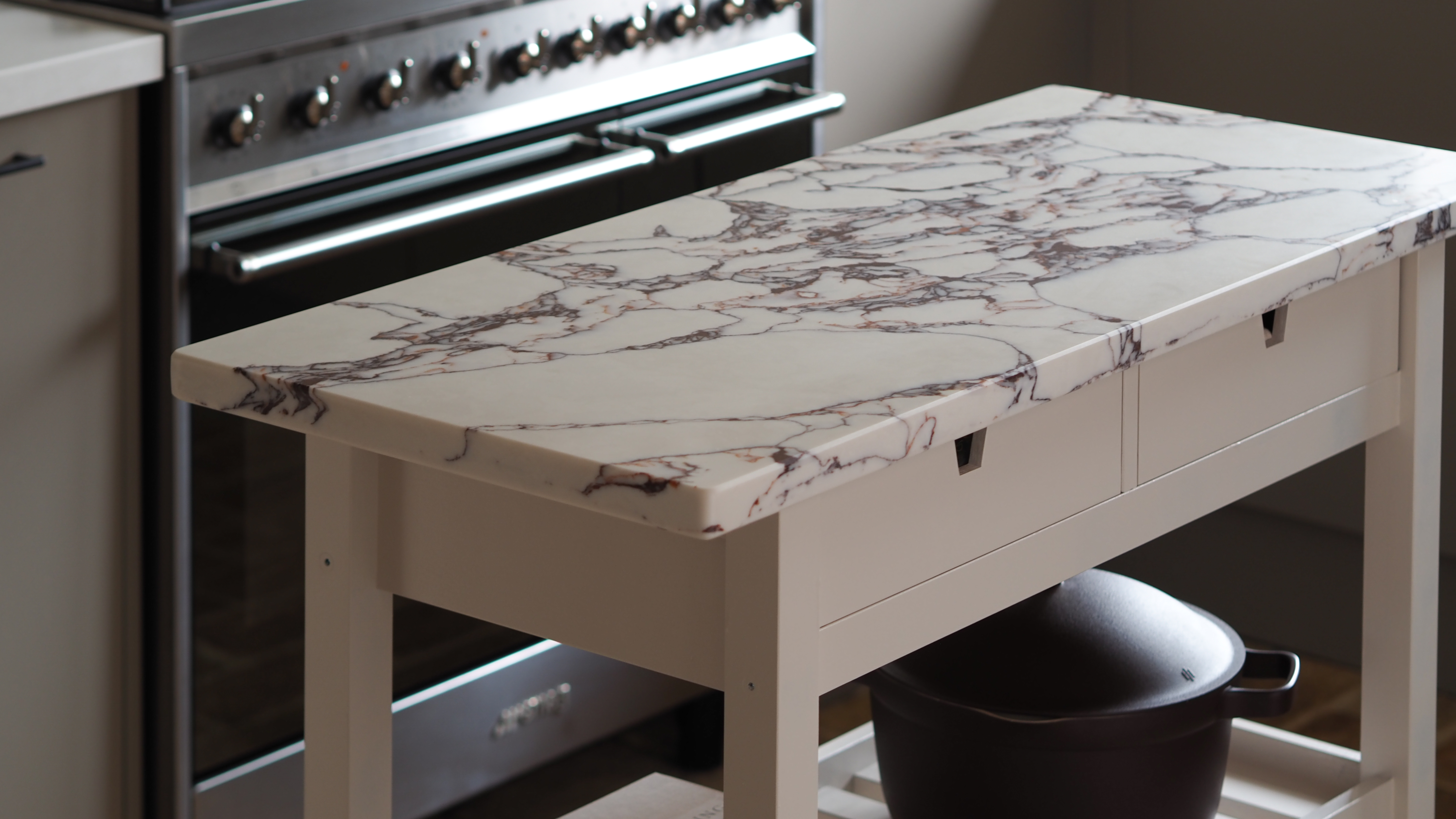 a marble topped beige kitchen island