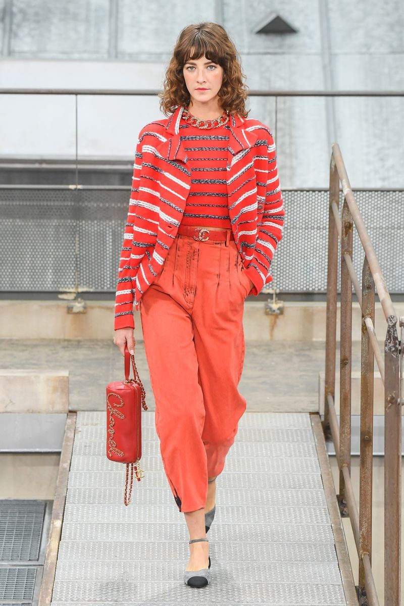 Clothing, Fashion model, Fashion, Orange, Red, Runway, Street fashion, Fashion show, Pantsuit, Waist,