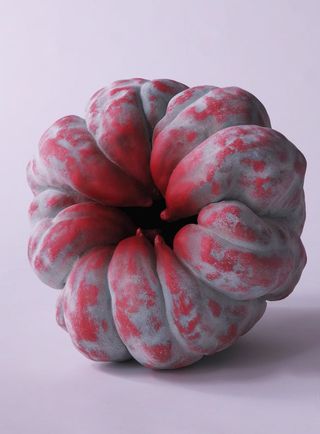 Decoration in the shape of a red and gray pumpkin.