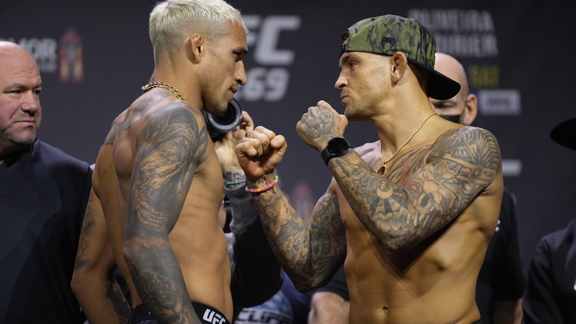 Charles Oliveira and Dustin Poirier facing off at a press conference for UFC 269