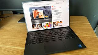 Dell Precision 5470 laptop open on wooden desk