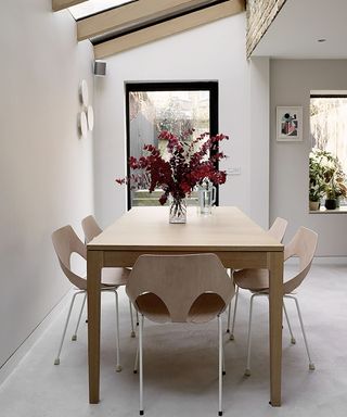 Scandinavian dining room painted in a neutral white paint color