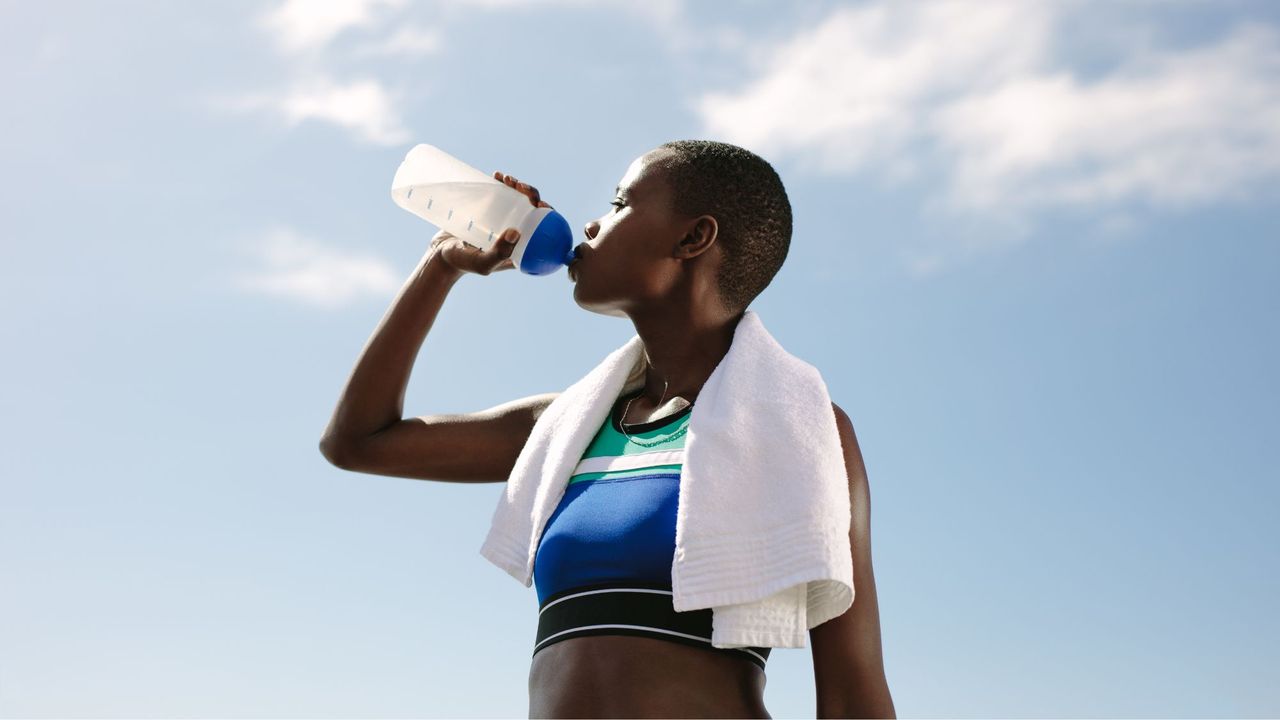 Can you build muscle with bodyweight exercises? A woman drinking a protein shake