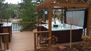 Master Spas hot tub under cover in large woodland lake area