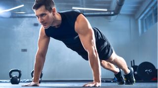 Man performing a push-up at a gym