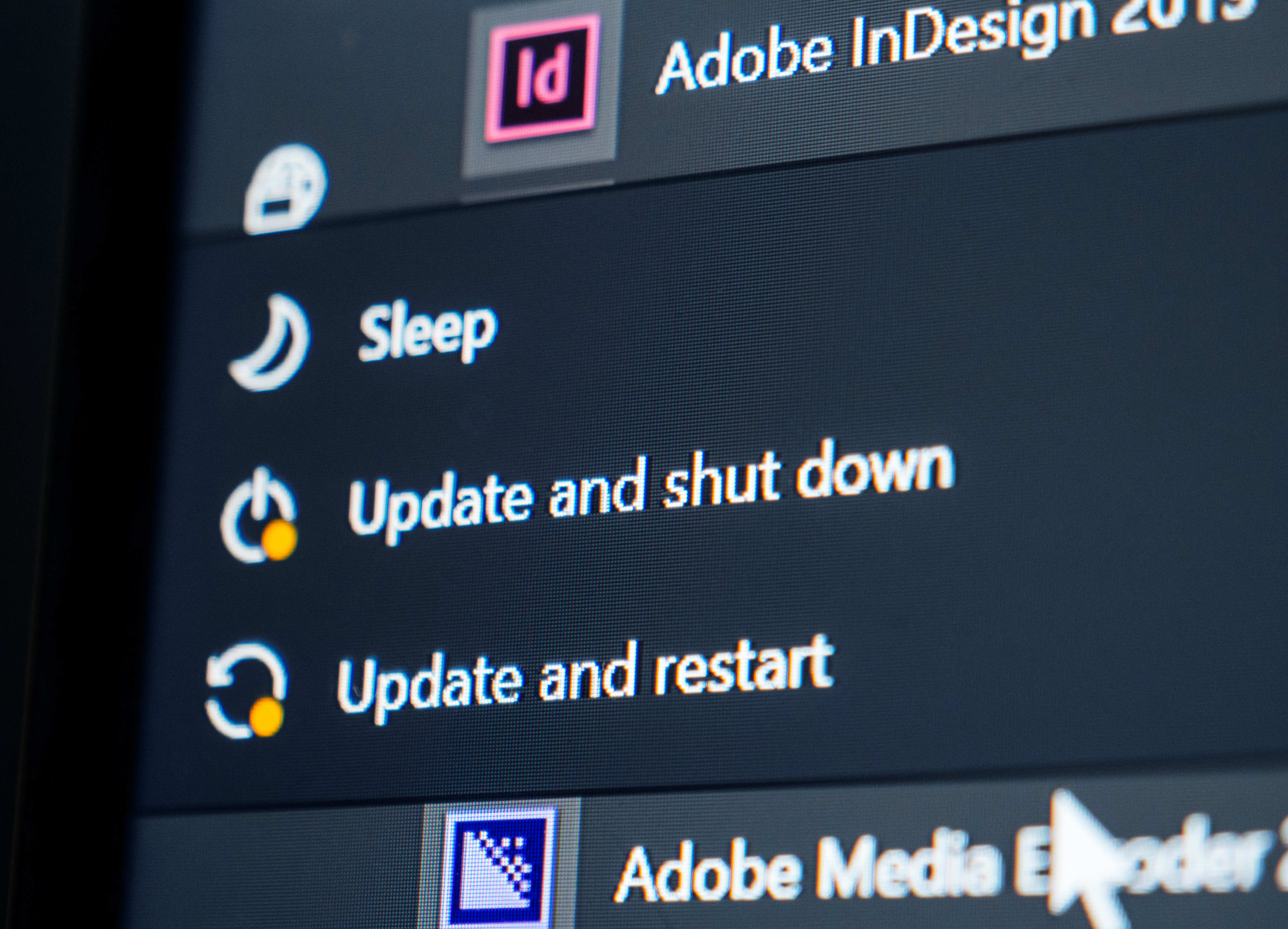 Macro close-up details of Start menu on a Personal Computer running Microsoft Windows 10 with Update and Shutdown and Update and restart options next to Sleep