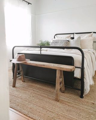 White bedroom and a bed with a metal bed frame