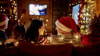 Family watching TV at Christmas