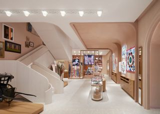 Inside of an Hermes store with marble stair case and vitrines of products