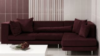 Living room with upholstered sofa and tiled walls in burgundy