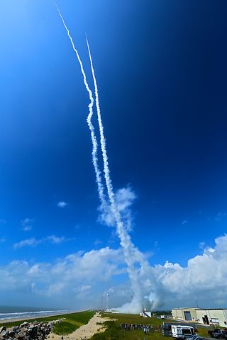 Contrails line the sky over Wallops Island, Va., on July 4, 2013 after two sounding rockets launched 15 seconds apart as part of the Daytime Dynamo experiment. A NASA Black Brant V was launched at 10:31:25 a.m. and was followed 15 seconds later by a Terrier-Improved Orion.