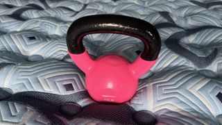 Testing the pressure relief for the Stearns & Foster Estate mattress review by using a kettlebell