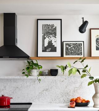 A white kitchen warmed up with a wooden shelf