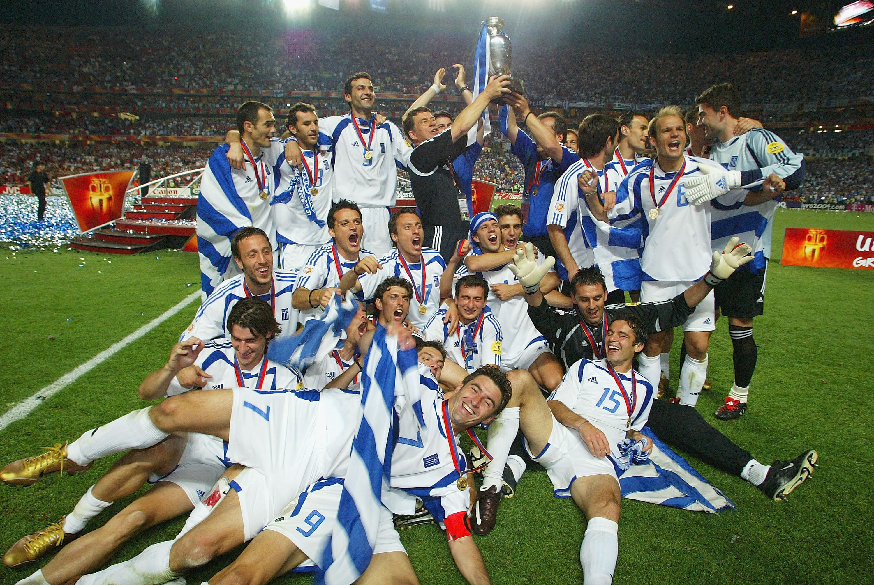 Greece players celebrate with the trophy after winning Euro 2004.