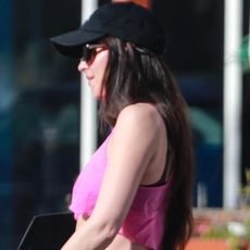 Dakota Johnson exercised in her signature athleisure set: black lululemon leggings and Nike V2K sneakers