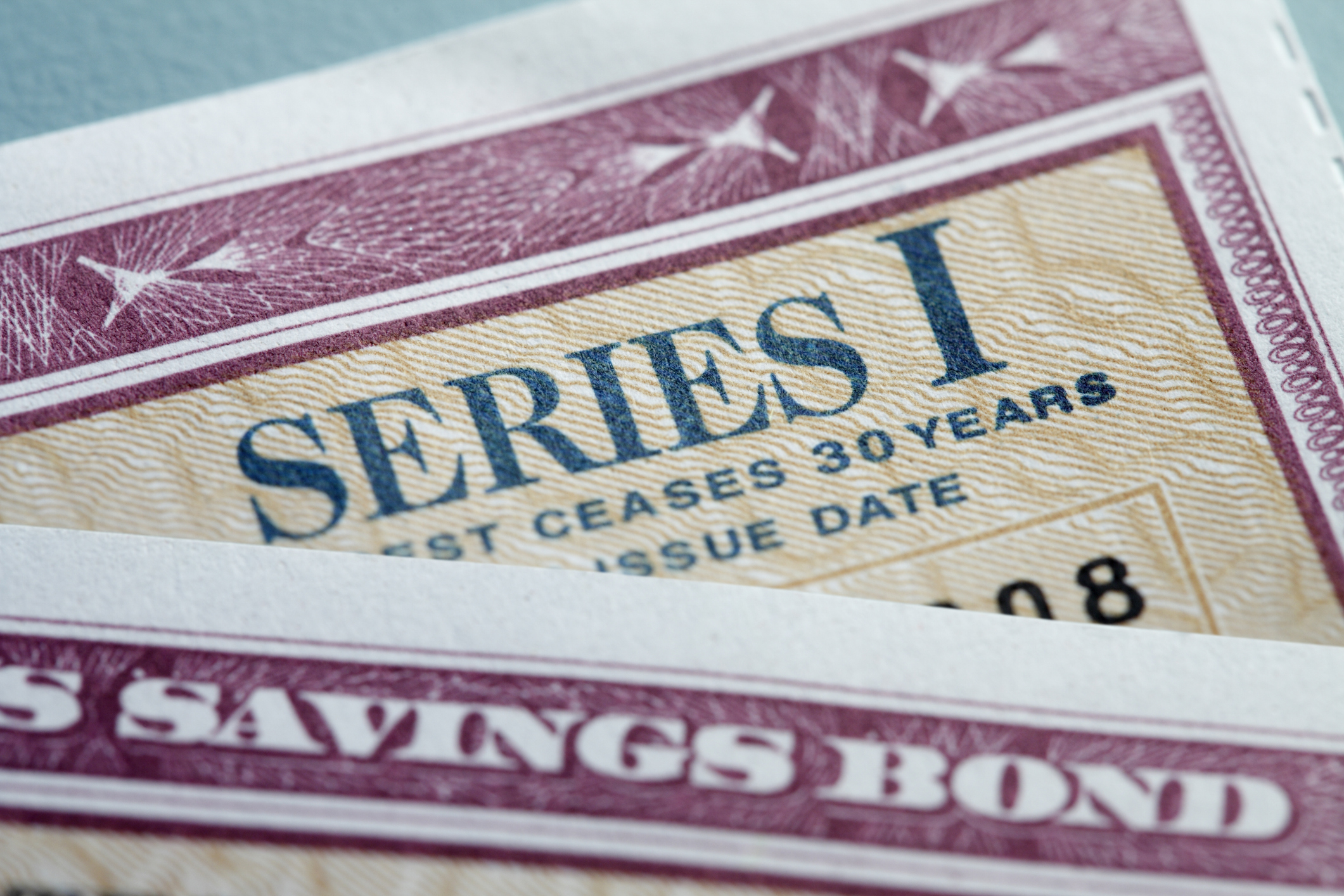 A close up of two U.S. government Series I Bonds stacked on top of each other.