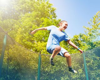 girl bouncing on a trampoline