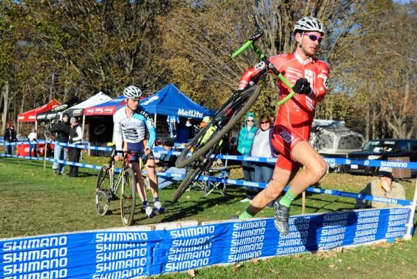Lukas Winterberg (Philadelphia Cyclocross School) leads Luke Keough (Champion System p/b Keough Cyclocross) through the barriers.