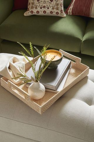 tray on ottoman with candle and plant