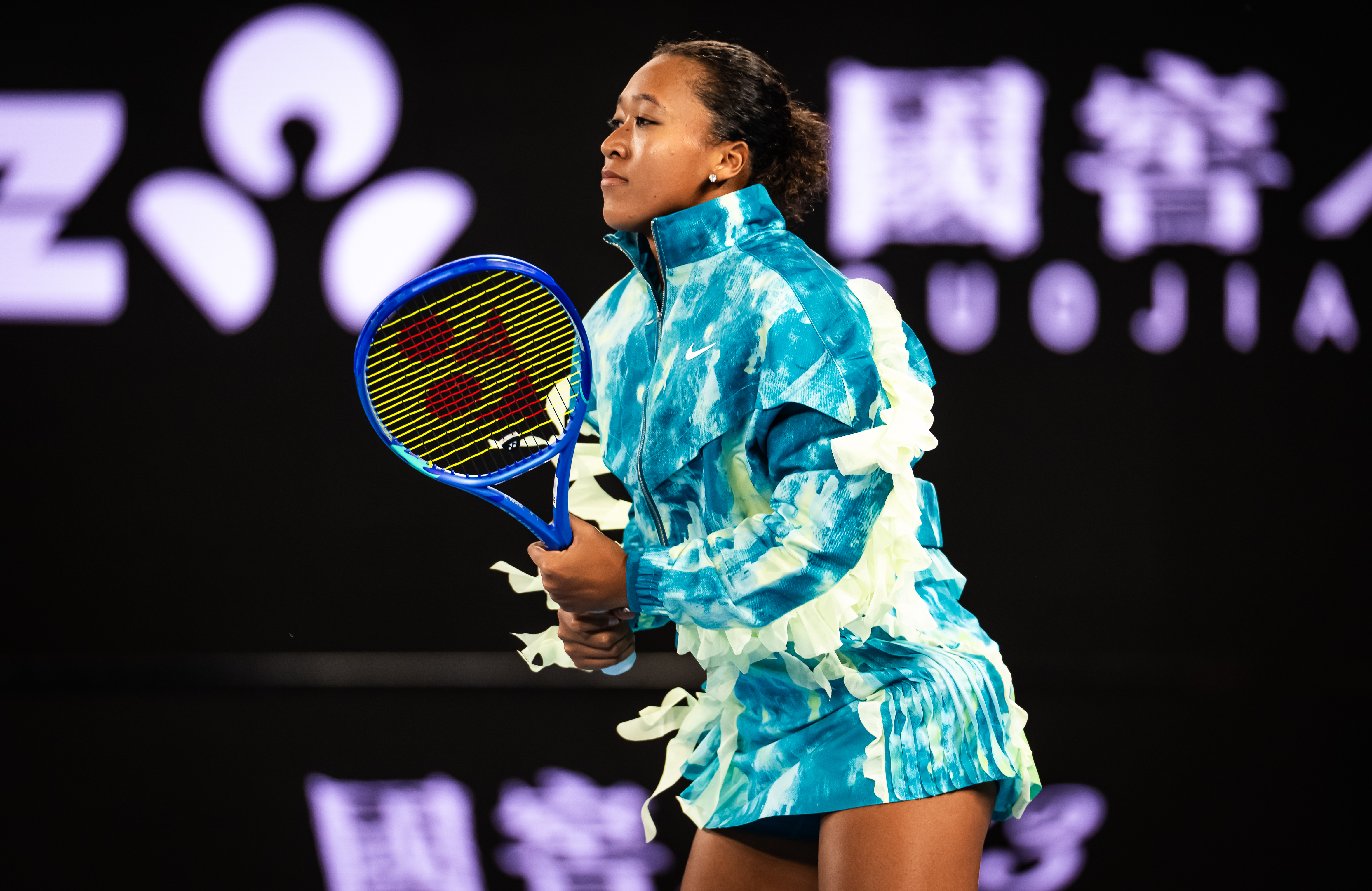 Naomi Osaka arrived at the 2026 Australian Open in a Robert Wun hat and umbrella, before revealing her tie-dye Nike athleisure