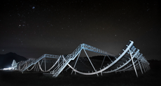 A photo shows the Canadian Hydrogen Intensity Mapping Experiment Fast Radio Burst Project at night.