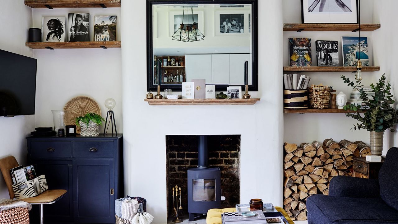 A white living room with fireplace and blue sofa