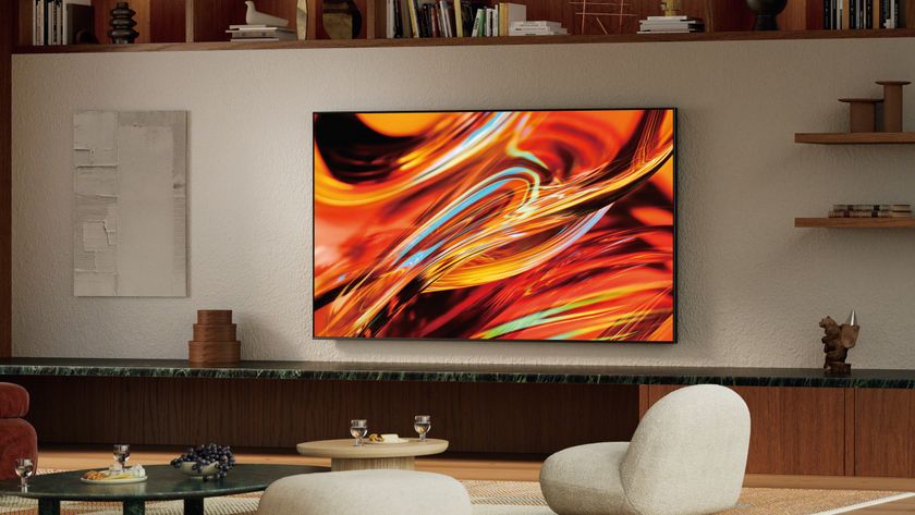A wall-mounted Sony Bravia 7 II True RGB Mini-LED TV displaying a colorful, abstract image in a modern living room