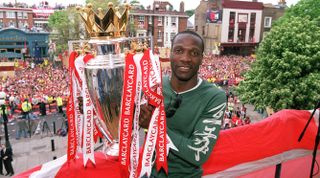 LONDON, ENGLAND - MAY 16: Lauren of Arsenal with the Premier League trophy during the Arsenal Trophy Parade on May 16, 2004 in London, England. (Photo by Stuart MacFarlane/Arsenal FC via Getty Images)