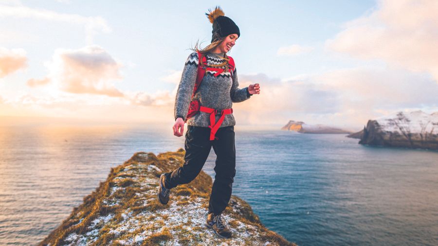 Woman on a mountaintop wearing Merrell Zion Gore-Tex Mid hikers