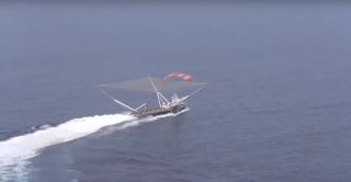 SpaceX's net-equipped boat, Mr. Steven, just misses catching a payload fairing half in this still from a video posted by SpaceX on Twitter on Jan. 7, 2018.