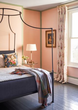 Bedroom with peach walls and wallpaper borders