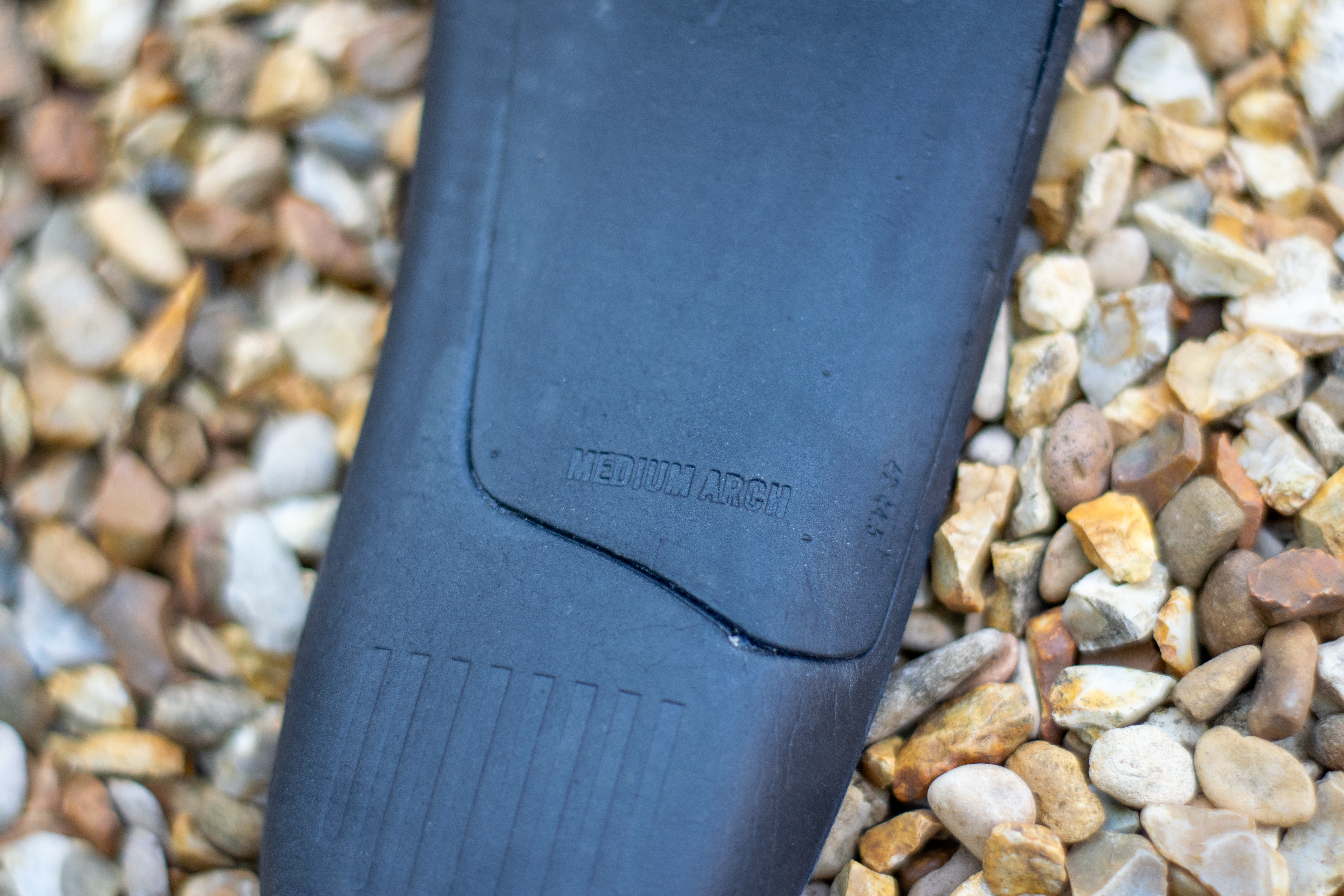 A Rapha Pro Team Gravel shoe on some gravel