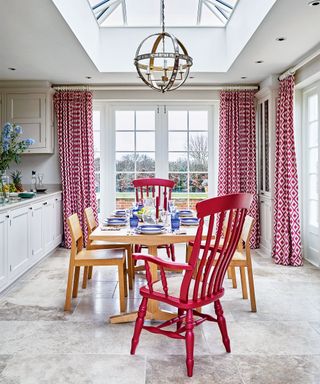 Red dining room with red and white curtains