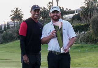 Tiger Woods and JB Holmes pose with the trophy at the 2019 Genesis Open