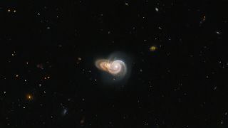 field of stars with two spiral galaxies stacked near the center of the image
