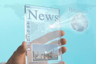 Transparent mini tablet computer displays news webpage