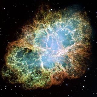 an image of the crab nebula, which green yellow and pink light