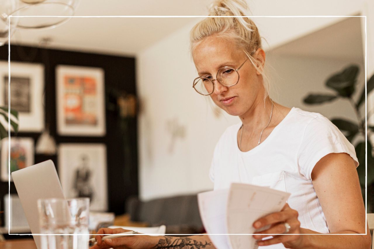 woman working from home on a laptop and consulting her diary