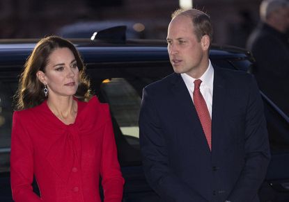 Prince William and Kate Middleton photographed in front of black car.