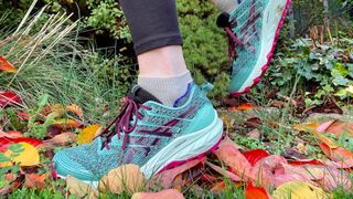 Woman's feet wearing Asics GEL-Trabuco 10 running shoes