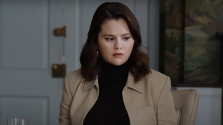 Black turtle-necked Selena Gomez looking confused in Only Murders in the Building