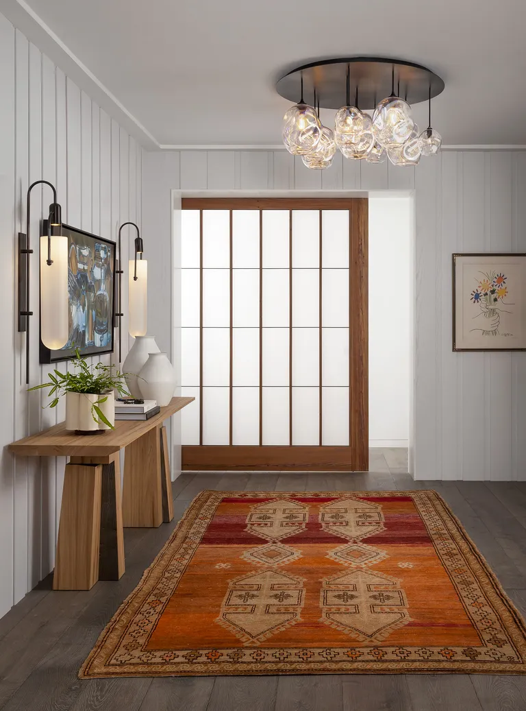 an apartment entryway with a glass door