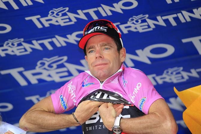 Cadel Evans dons the pink leader's jersey