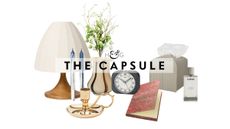 Bedside table decor pictured against a white background, including a table lamp, taper candle duo, brass candlestick, striped vase, retro-style alarm clock, patterned notebook, woven leather tissue cover, and Loewe Home spray