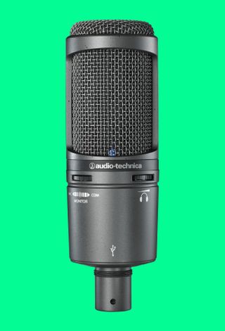 The Audio Technica AT2020USB+ microphone on a green background